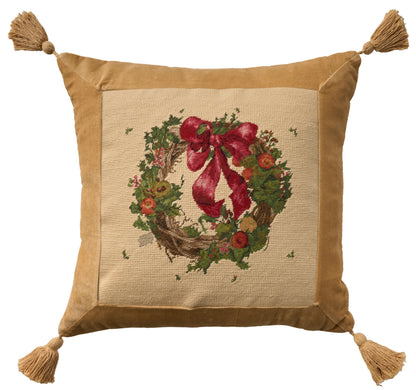 Tan velvet bordered throw pillow with a burlap center featuring a Christmas wreath and red bow; tassels on all four corners.