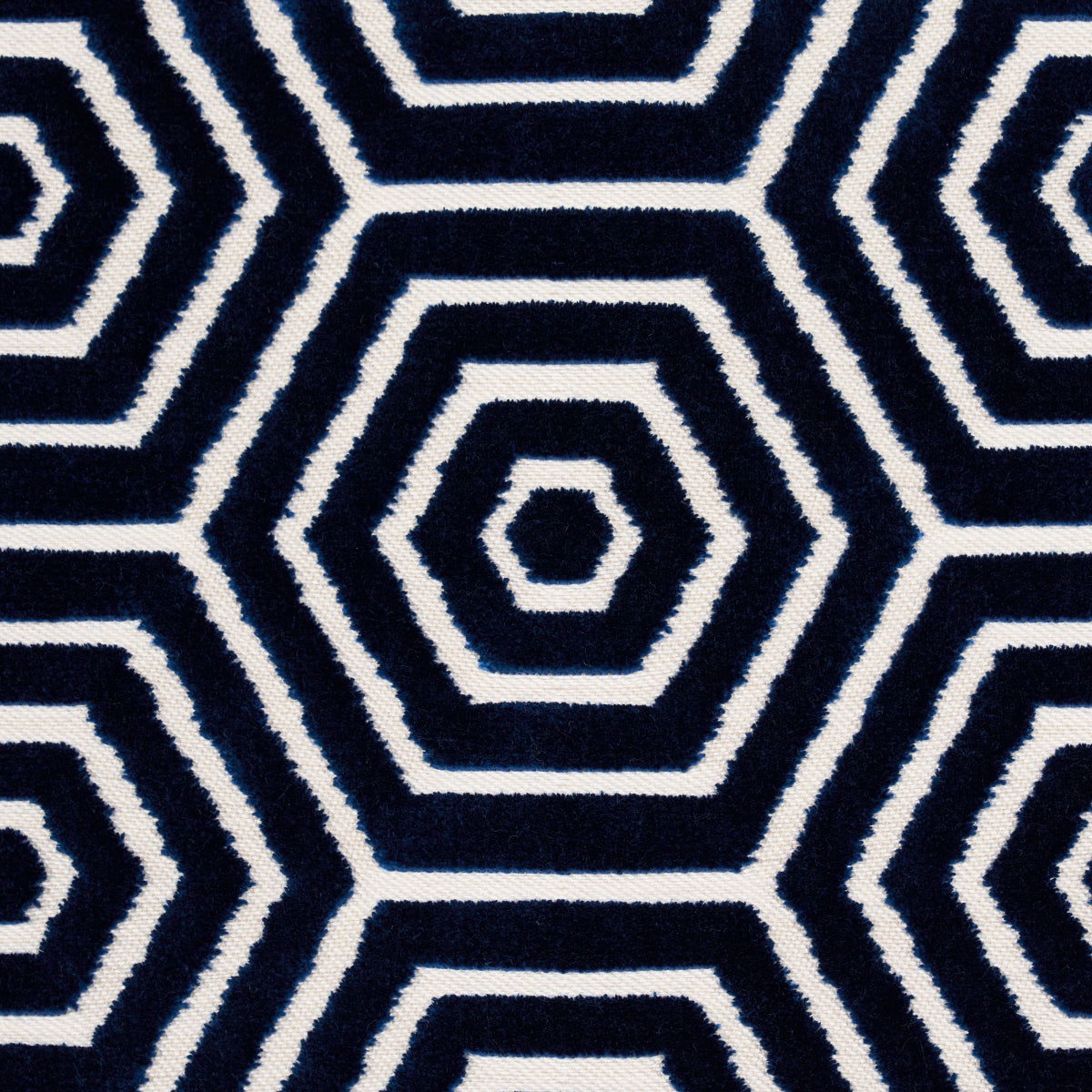 Navy blue and white geometric hex pattern textile with concentric hex rings, rug or throw fabric.