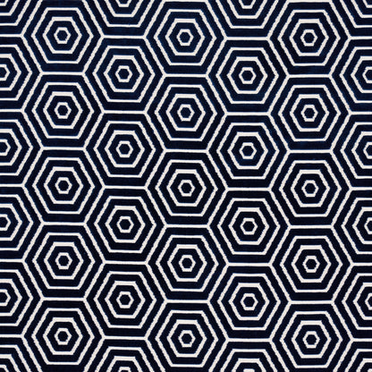 Dark navy fabric with a repeating white nested hexagon pattern; bold geometric print for upholstery or cushions.