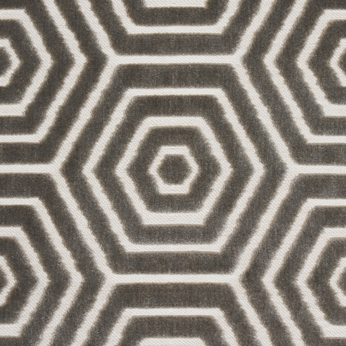 Gray and cream hexagon pattern rug with concentric rings; geometric woven textile.