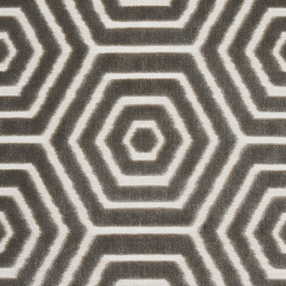 Gray and cream hexagon pattern rug with concentric rings; geometric woven textile.