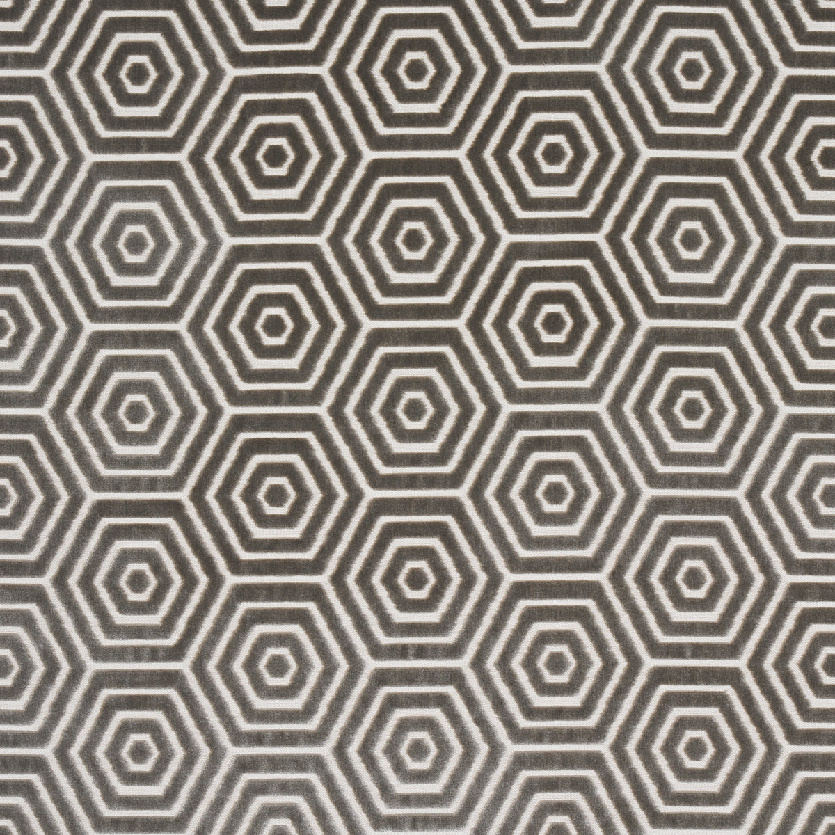 Close-up of dark gray fabric or wallpaper with white concentric hexagon geometric pattern.
