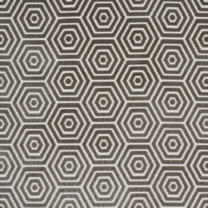 Close-up of dark gray fabric or wallpaper with white concentric hexagon geometric pattern.