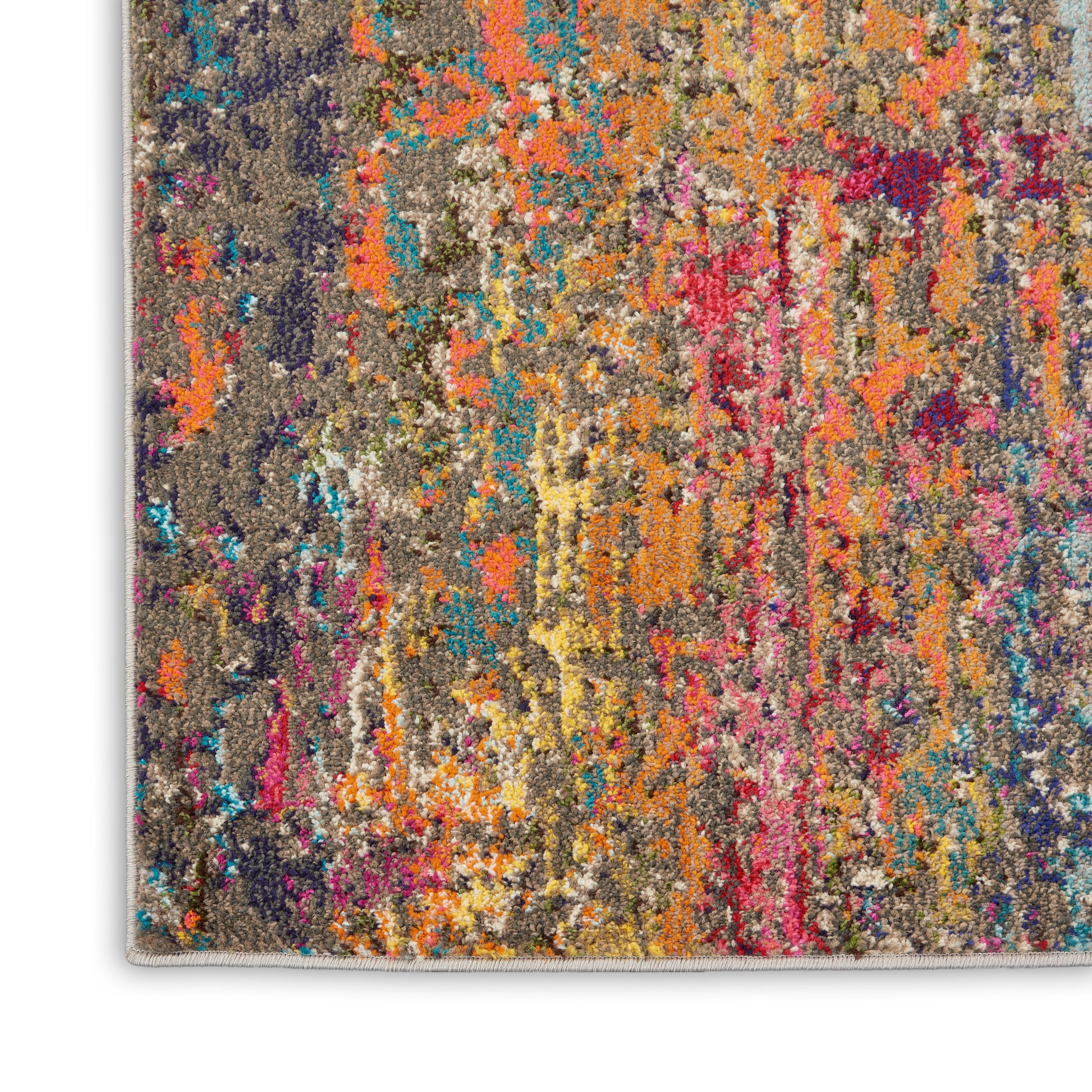 Shaggy abstract area rug with multicolor splashes on gray base; tufted pile and light fringe.
