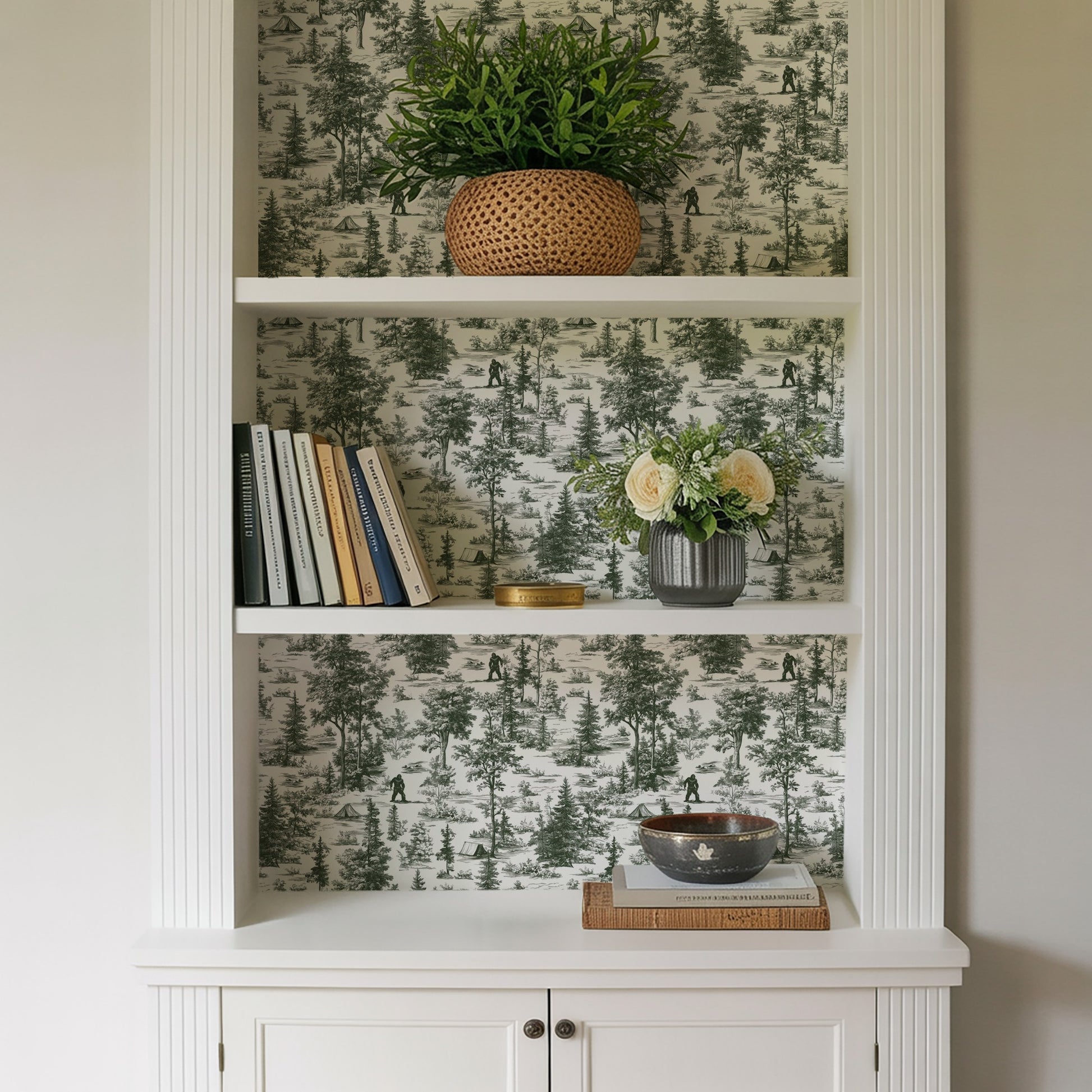 Green toile peel-and-stick wallpaper with a novelty Bigfoot landscape motif.