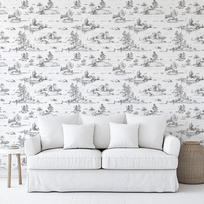 White sofa with three square cushions against toile wallpaper; light-wood side table and woven basket.