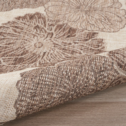 Beige & brown floral woven rug with textured jacquard look, rolled corner.