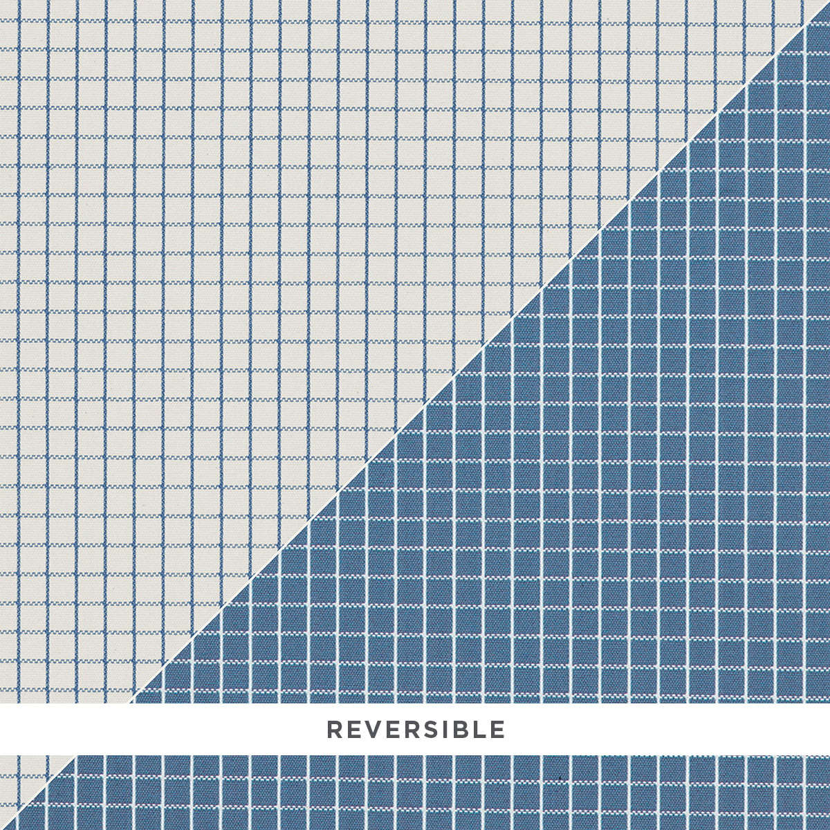 Reversible grid-pattern rug with pale white on one side and deep blue on the other, diagonal seam.