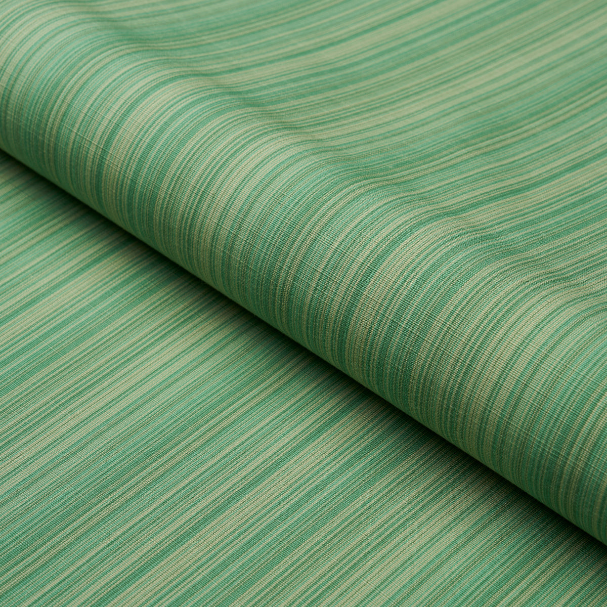 Rolled green striped fabric with thin lighter and darker green lines, linen-like weave for upholstery or crafts.