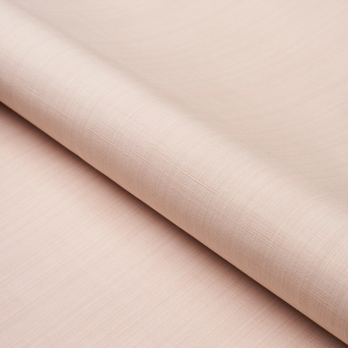 Soft blush pink linen-like fabric, fine weave, folded roll; ideal for garments or home textiles.