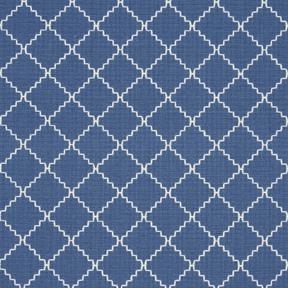 Blue fabric with white interlocking quatrefoil lattice woven textile for upholstery or curtains.