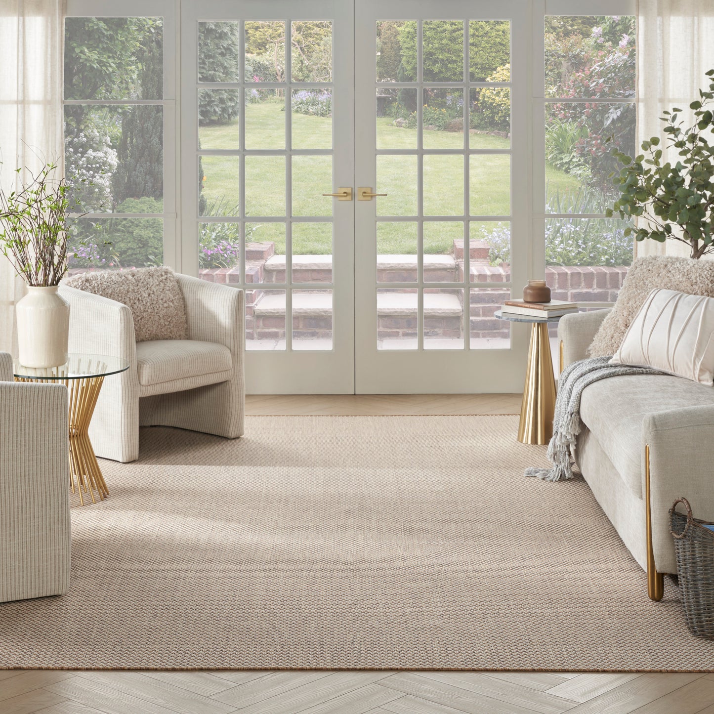Bright beige modern rug (10' x 14') with natural jute texture in a living room.