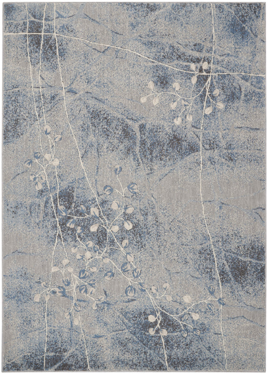 Rectangular blue-gray rug with speckled backdrop and white vine pattern; modern botanical look.