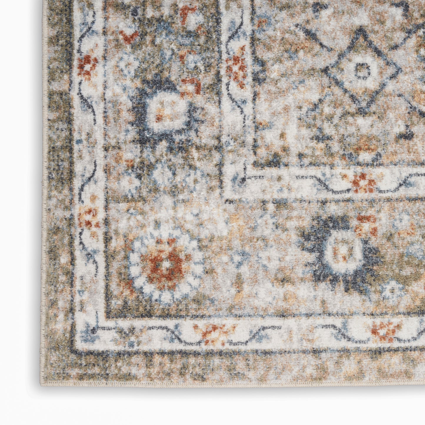 Distressed traditional oriental rug corner with muted blue, gray, rust and floral medallion border.