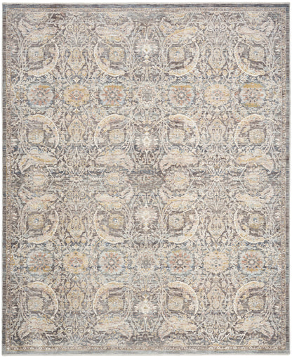 Rectangular distressed vintage-style area rug with repeating damask medallions in gray, beige and ivory.