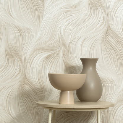 Beige Waves of Light wallpaper pattern as backdrop, with a beige ceramic pedestal bowl and taupe vase on a round light wood table.