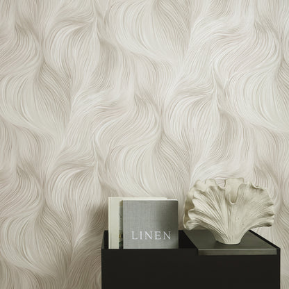 Cream linen-pattern wallpaper with flowing waves; black stand holds a gray 'LINEN' book and a white shell sculpture.