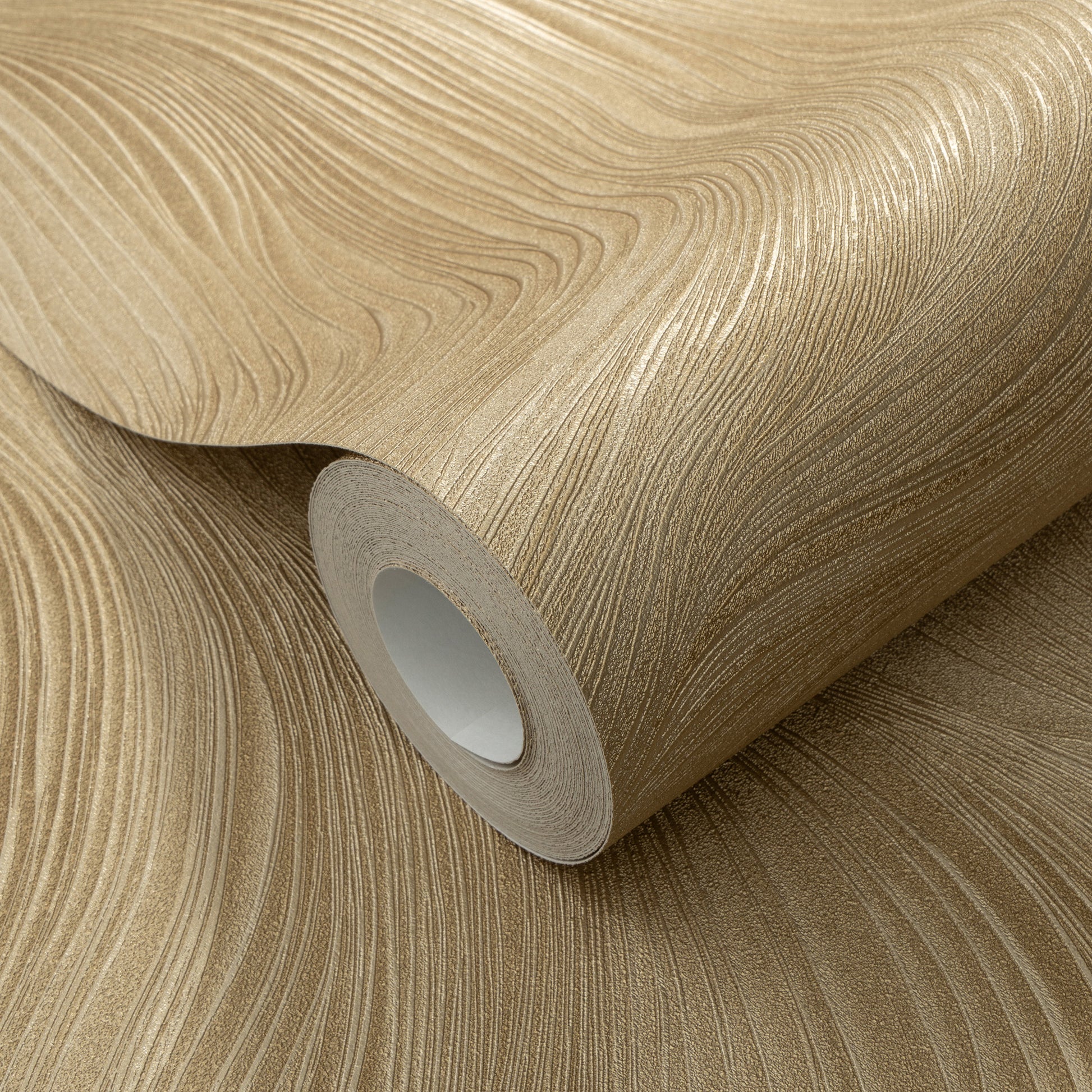 Beige-gold textured wallpaper roll with wave pattern, curled edge and visible inner core.
