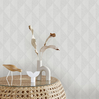 Gray wallpaper with a woven diamond pattern.