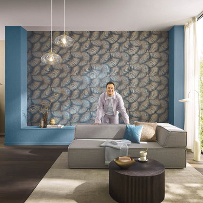 Blue palm-pattern wallpaper accent wall with teal alcoves, modern gray modular sofa, round dark wood coffee table, glass pendant lights.
