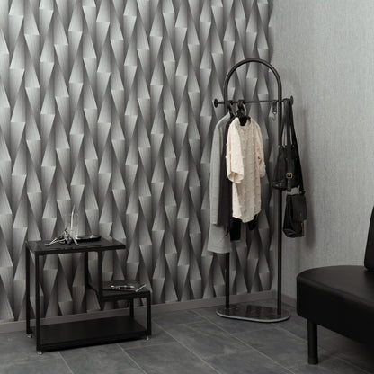 Gray geometric wallpaper with a black metal round-top coat rack, scarves and bags, beside a glass-top console table.