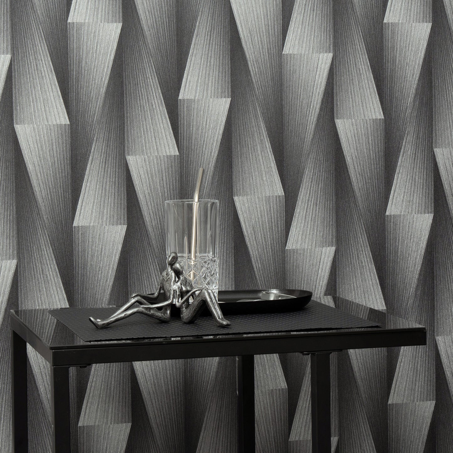 Close-up of silver wallpaper with a subtle metallic geometric pattern.