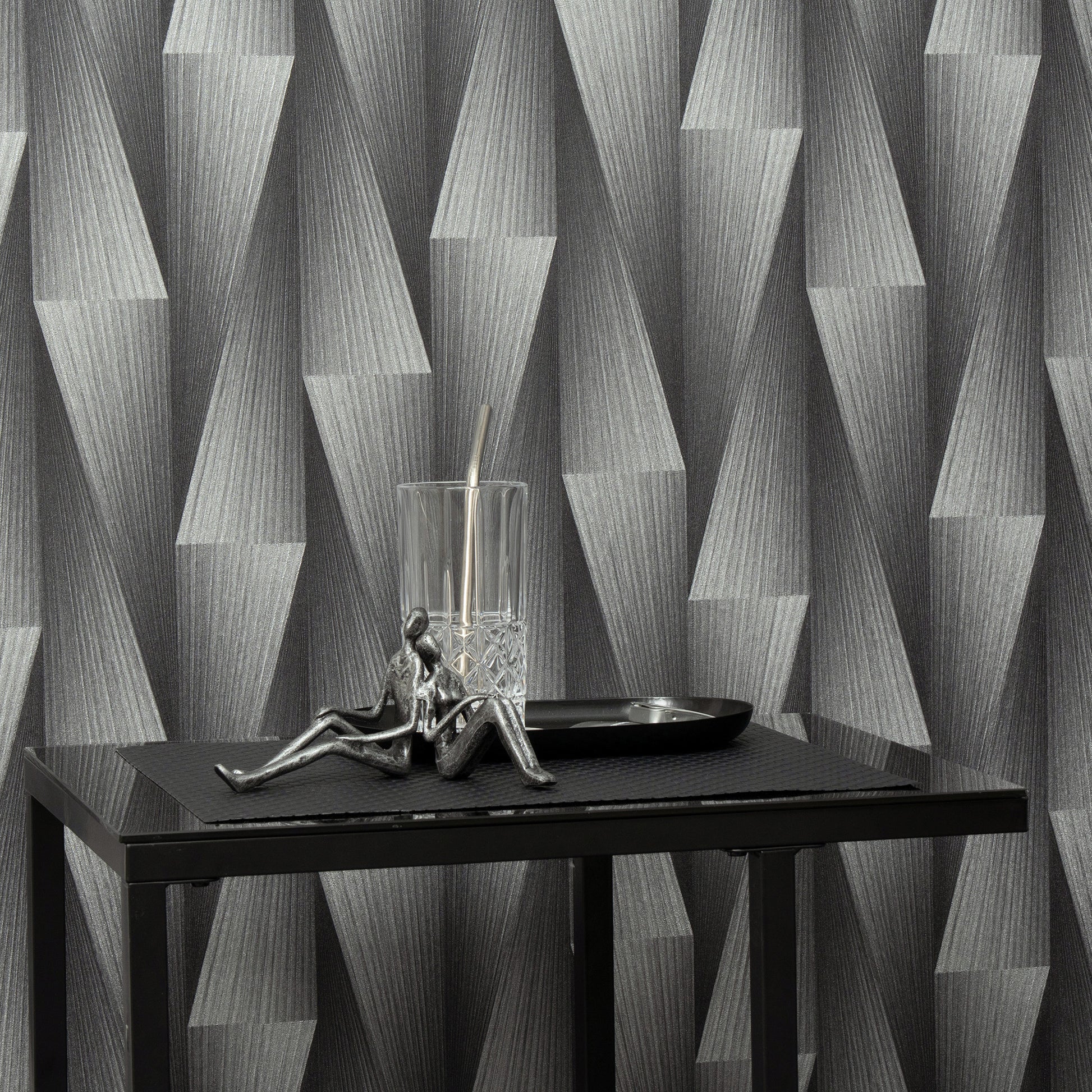 Close-up of silver wallpaper with a subtle metallic geometric pattern.