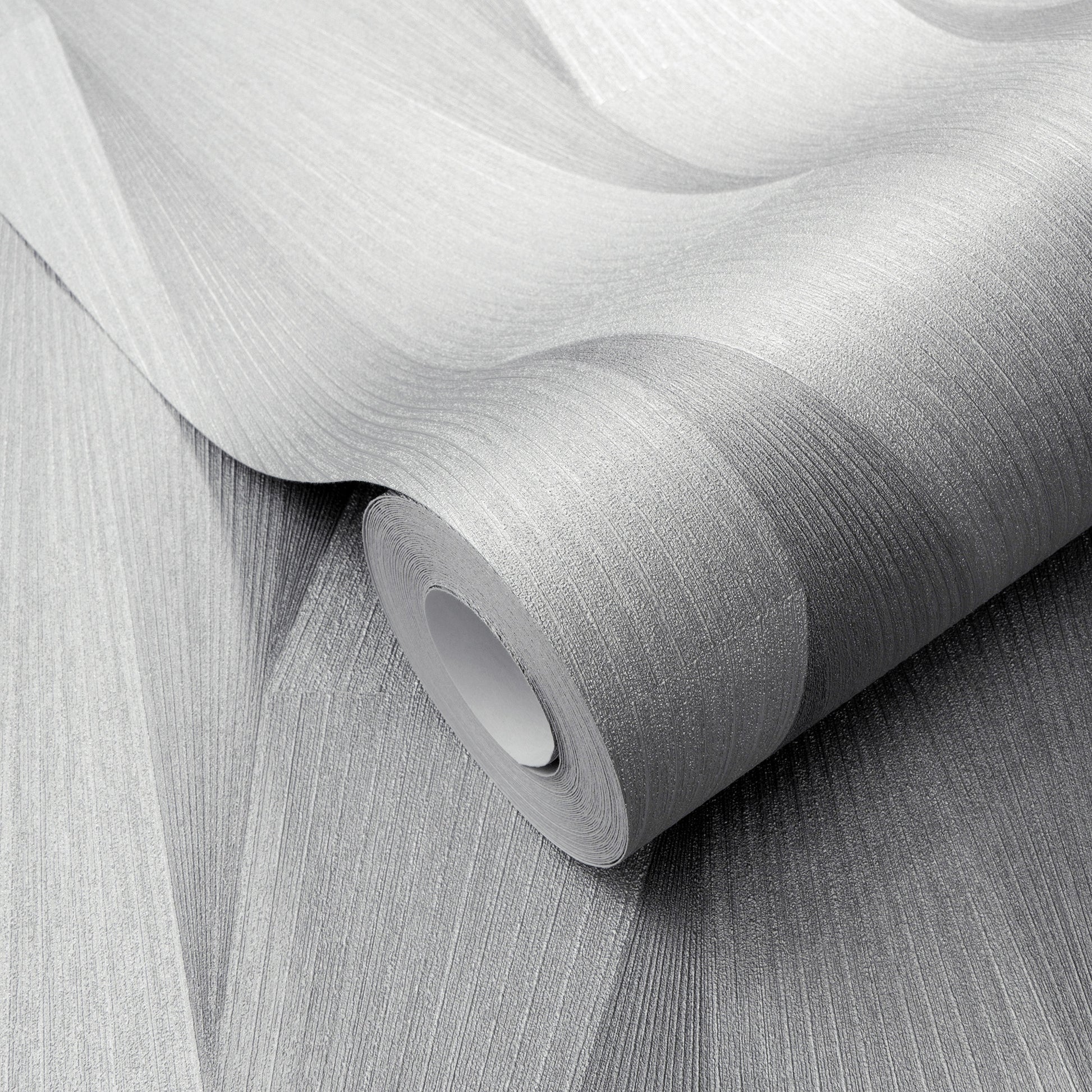 Light gray textured wallpaper roll with fine linear ribbing and matte finish, partially unrolled.