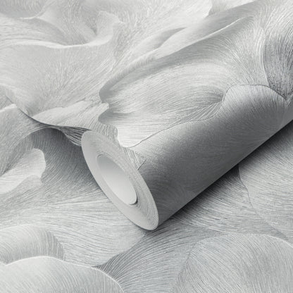 Wallpaper roll in silver-gray with abstract leaf pattern and subtle textured finish.