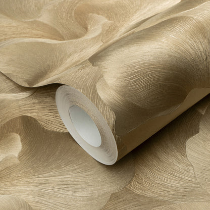 Gold metallic textured wallpaper roll with floral pattern and white core.