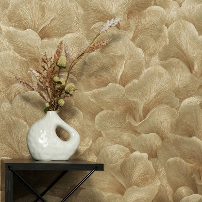 White ceramic vase with a loop handle on a dark shelf, against gold beige palm-leaf wallpaper and dried floral stems.
