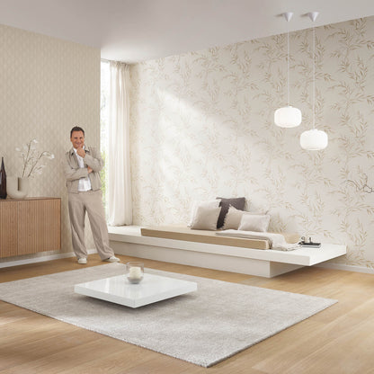 Minimalist living room with beige botanical wallpaper, light wood floor, white platform sofa, and square white coffee table.