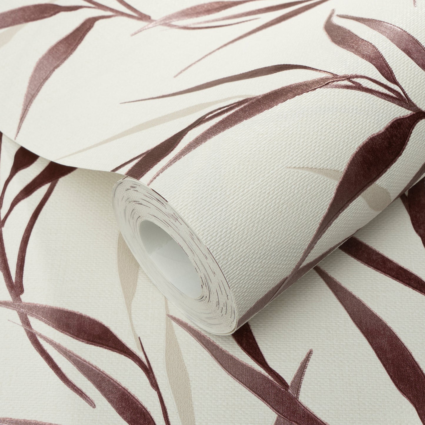 Roll of vinyl wallpaper with red background and botanical leaves; textured pattern.
