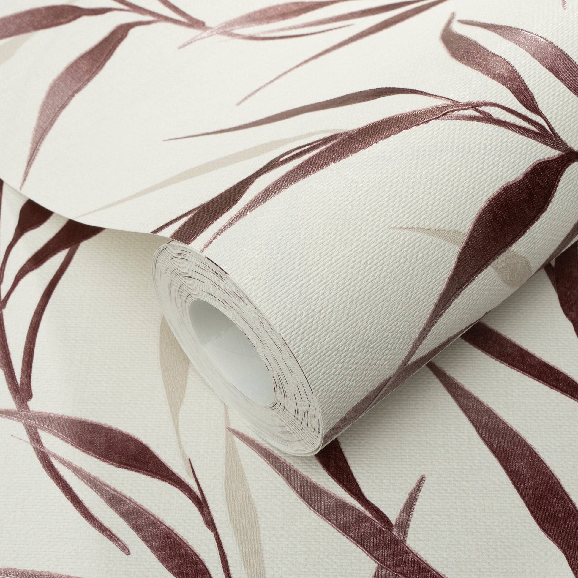 Roll of vinyl wallpaper with red background and botanical leaves; textured pattern.
