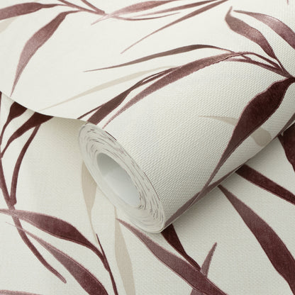 Roll of vinyl wallpaper with red background and botanical leaves; textured pattern.
