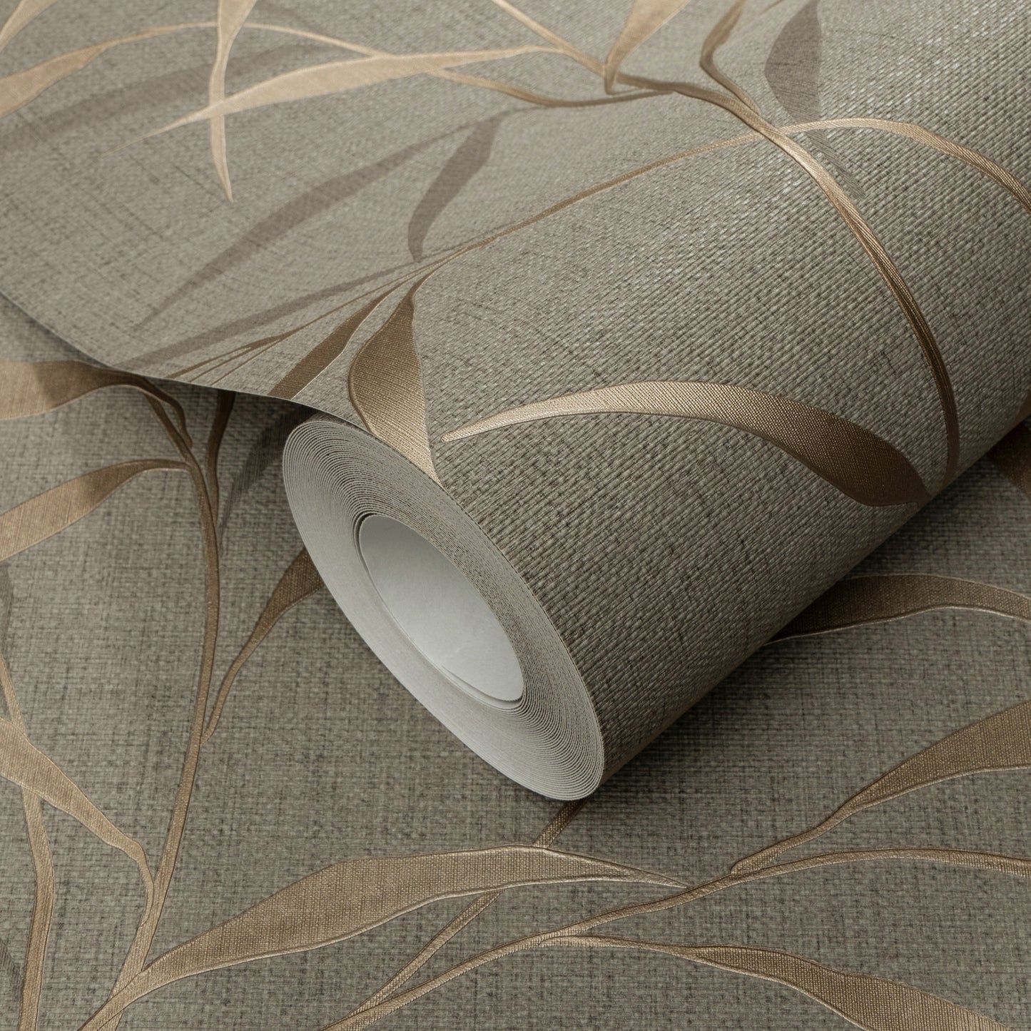 Roll of brown wallpaper with a linen-like texture and botanical leaf pattern.