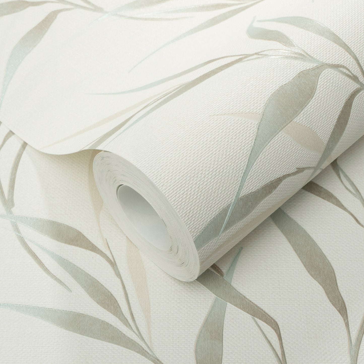 Roll of teal leaves botanical wallpaper on a white linen-textured backdrop.