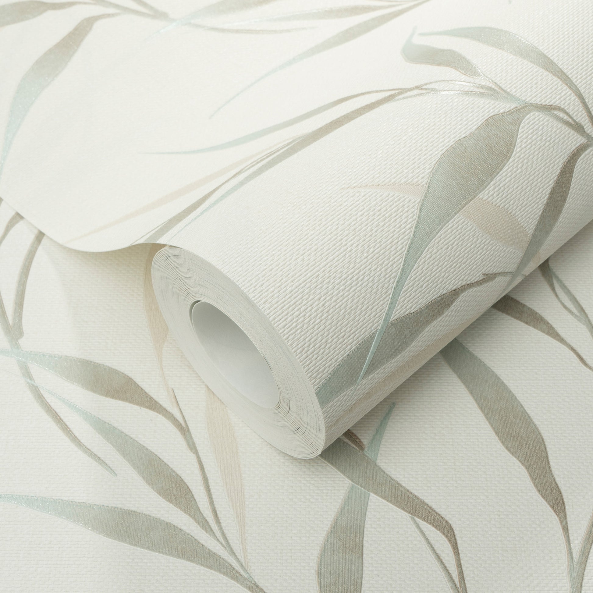 Roll of teal leaves botanical wallpaper on a white linen-textured backdrop.
