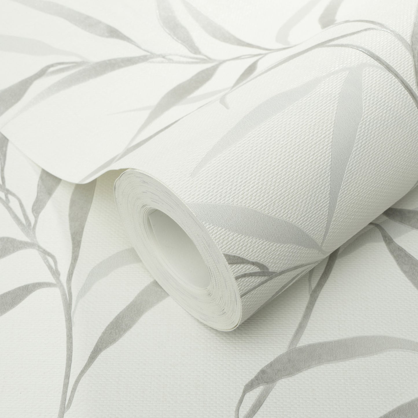 Roll of white wallpaper with light gray botanical leaf pattern; vinyl, textured, rolled up.