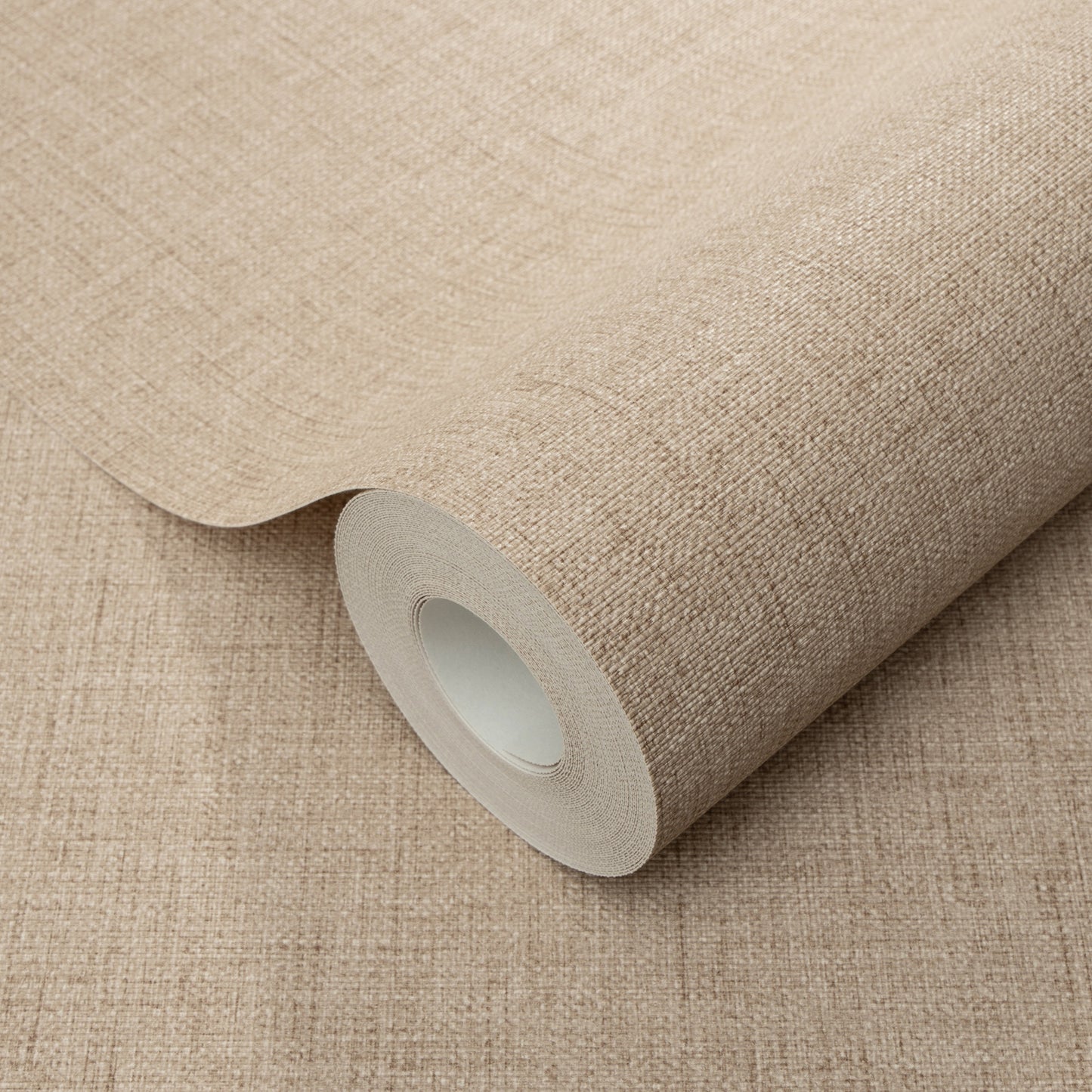 Beige fabric-textured wallpaper roll, partially unrolled, showing woven pattern and inner core.