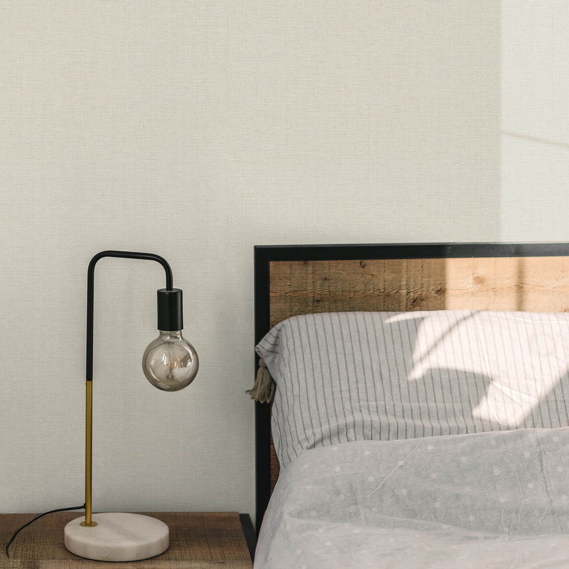 Sepia-toned wallpaper with a woven jute texture and an abstract traditional pattern.