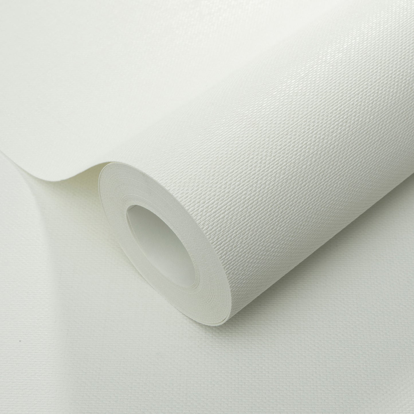 White textured fabric roll with a subtle woven pattern, partially unrolled; suitable for upholstery or wallpaper.
