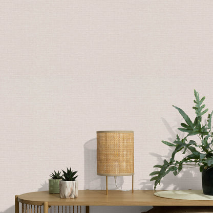 Pink wallpaper with a subtle jute texture and an abstract traditional pattern.