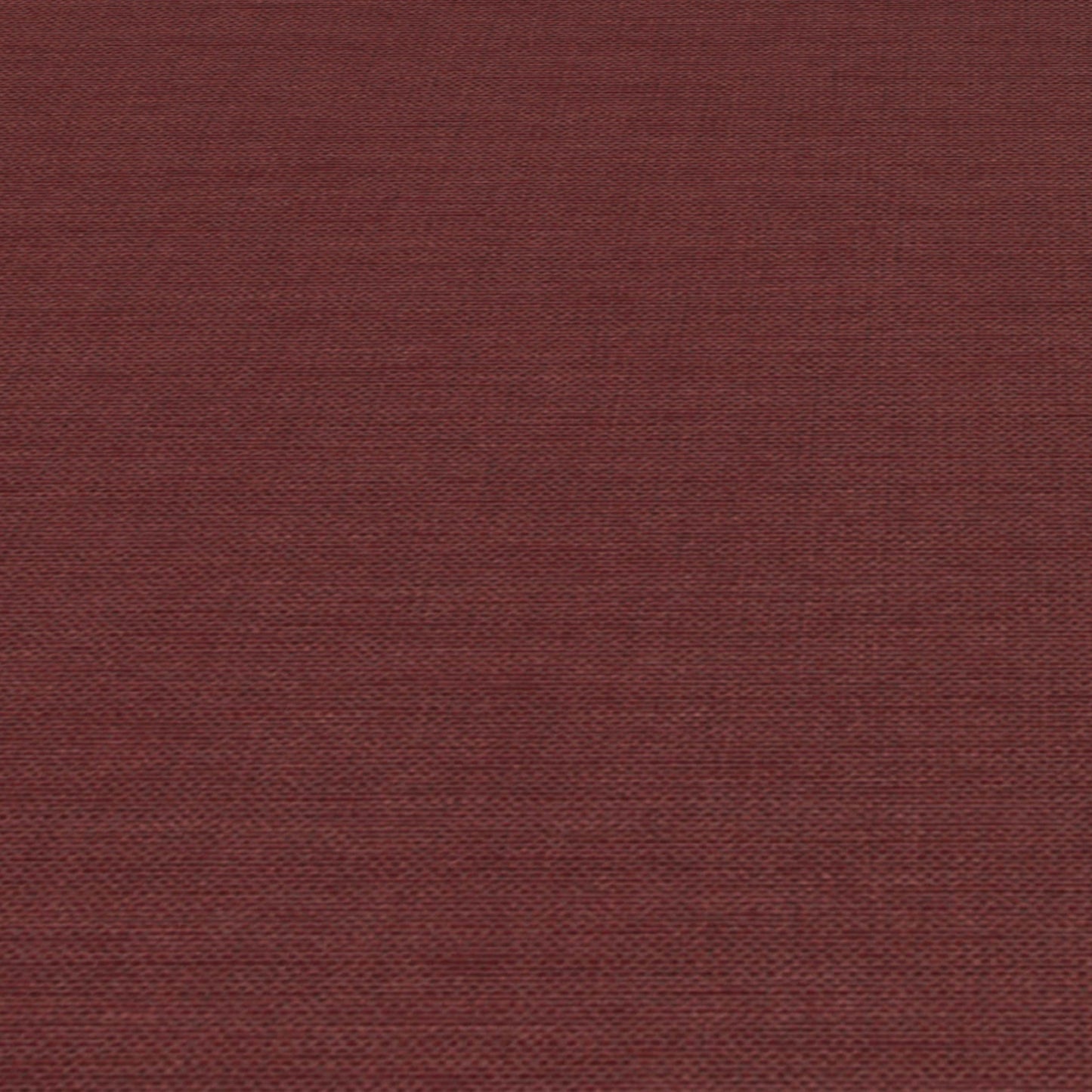 Rust-red jute-textured wallpaper close-up with visible fibers and subtle woven pattern.