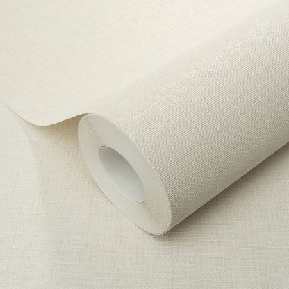 Cream jute-texture wallpaper roll on beige surface, fabric-like pattern with white inner core