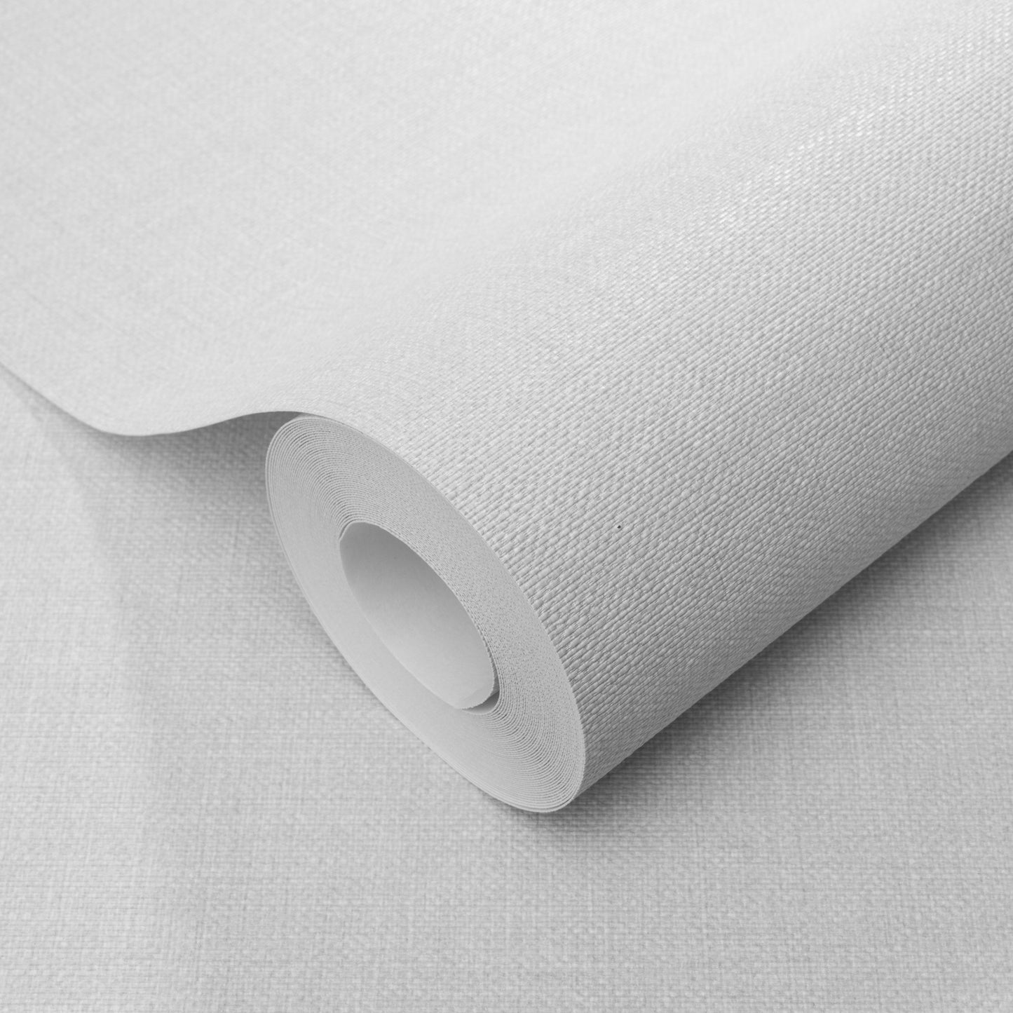 Gray wallpaper roll with a woven jute texture, rolled around a cardboard core.