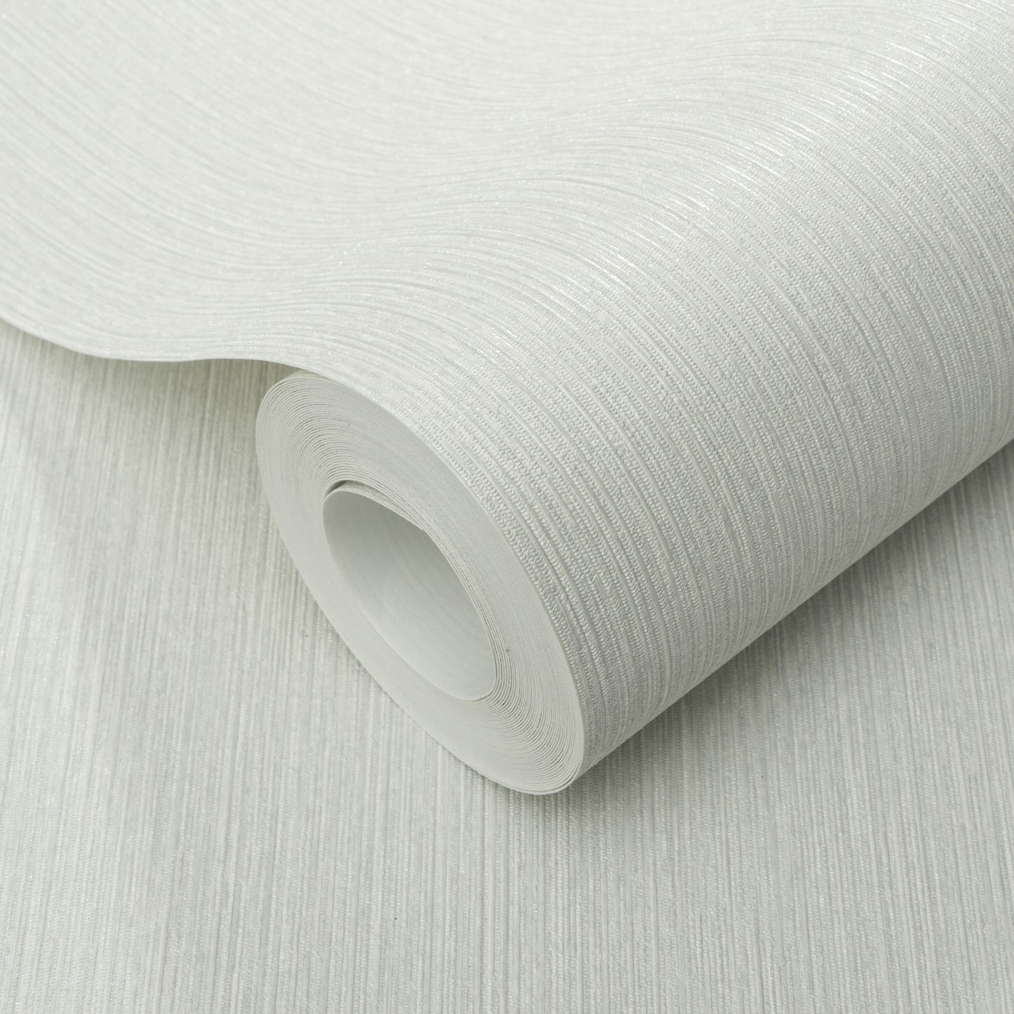 Roll of gray textured wallpaper with a fine linear pattern; close-up view.