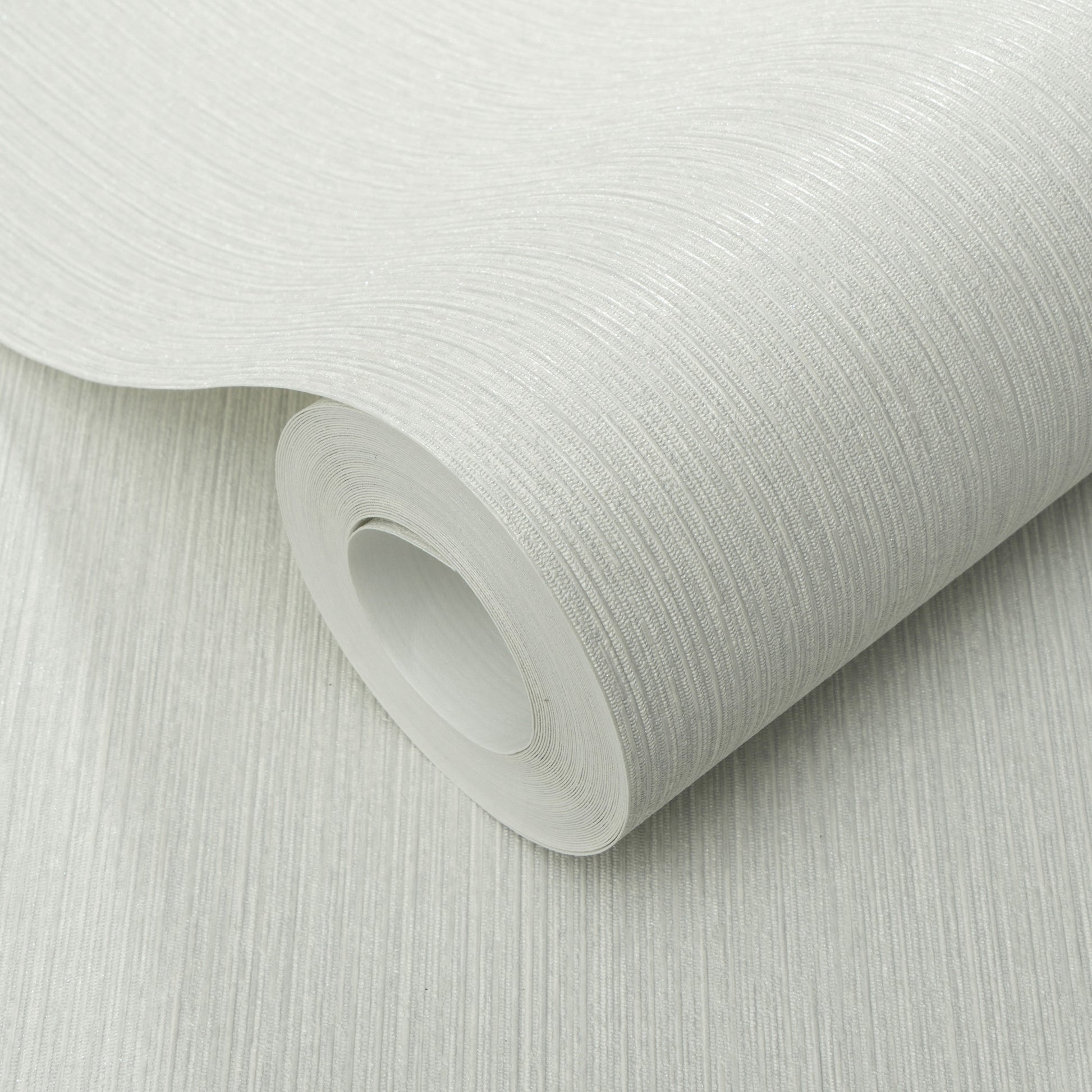 Roll of gray textured wallpaper with a fine linear pattern; close-up view.