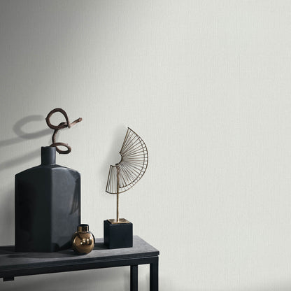 Gray wallpaper with a soft loom stria texture and an abstract traditional pattern.