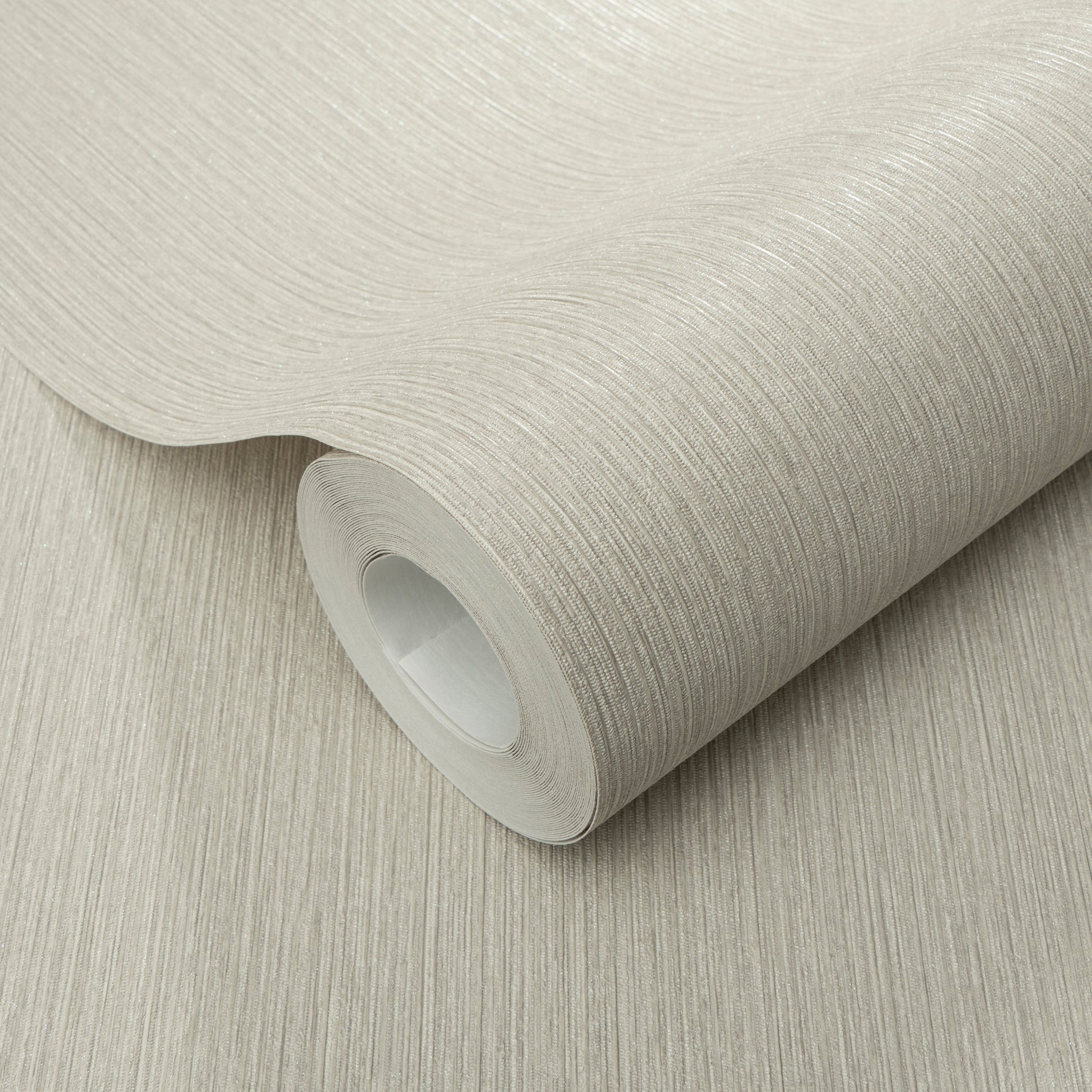 Cream-beige textured wallpaper roll with subtle vertical linear grain, rolled around a white core.